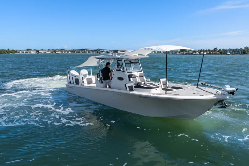 Slide: The Image of 2024 Tidewater 3100 Carolina Bay boat cruising on a sunny day. - 16