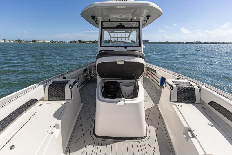 Slide: The Image of 2024 Tidewater 3100 Carolina Bay boat interior on open water, featuring spacious deck and storage. - 52