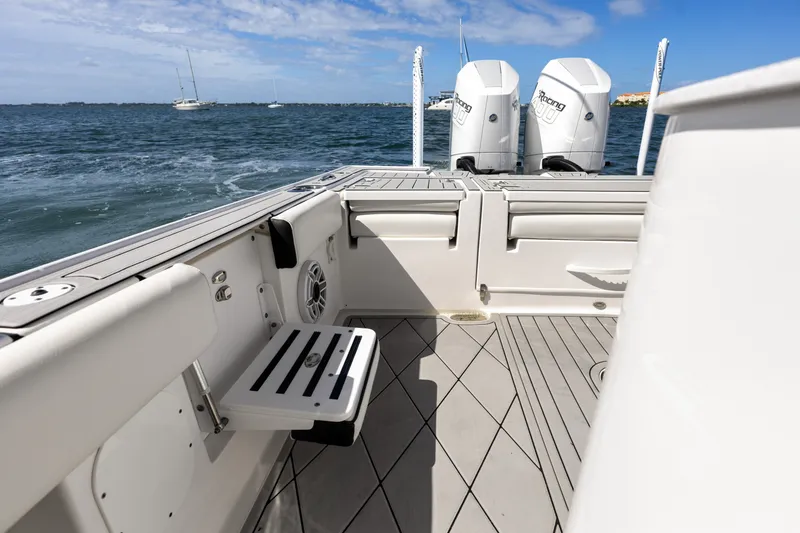 Slide: The Image of 2024 Tidewater 3100 Carolina Bay boat interior with dual engines on open water. - 34
