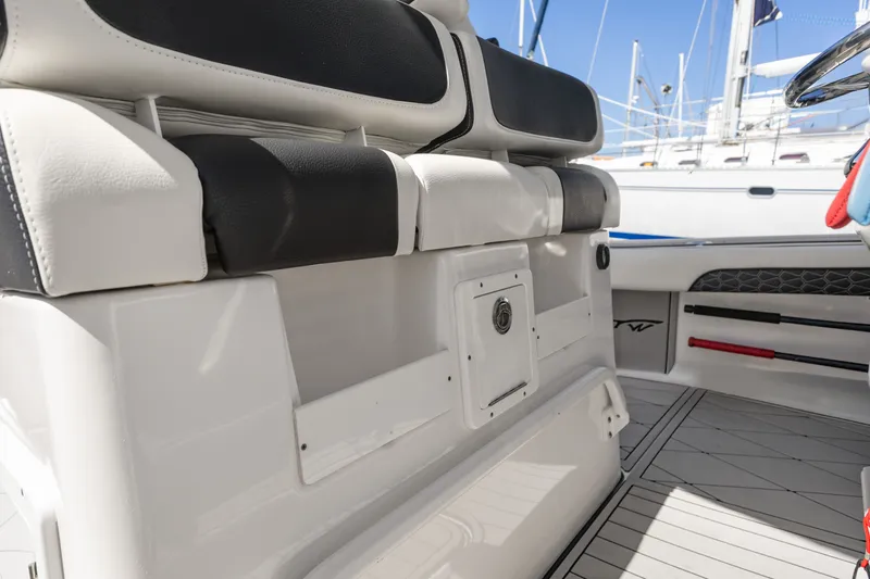 Slide: The Image of 2024 Tidewater 3100 Carolina Bay boat interior with cushioned seating and storage compartments. - 38