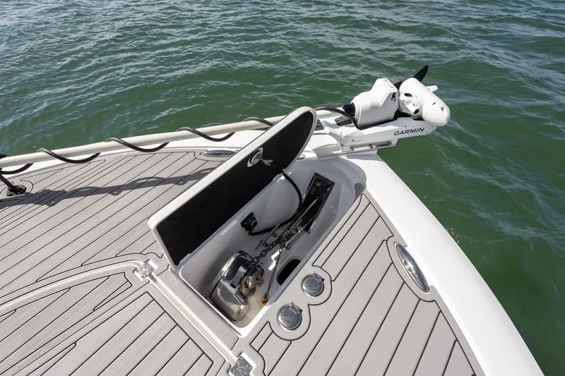 Slide: The Image of 2024 Tidewater 3100 Carolina Bay boat deck with Garmin equipment and anchor storage. - 49