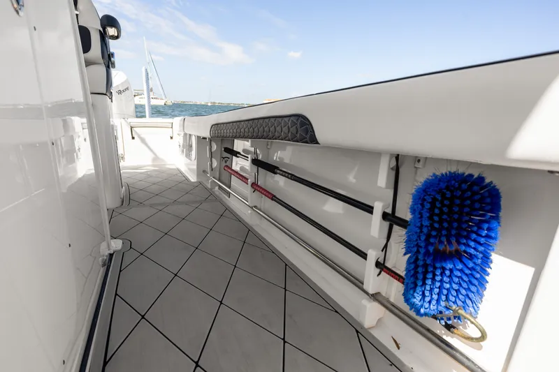 Slide: The Image of 2024 Tidewater 3100 Carolina Bay boat interior with storage and cleaning tools. - 55