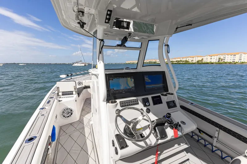 Slide: The Image of 2024 Tidewater 3100 Carolina Bay boat interior with advanced navigation system on open water. - 40