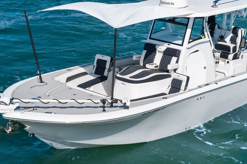 Slide: The Image of 2024 Tidewater 3100 Carolina Bay boat cruising on clear blue water. - 15