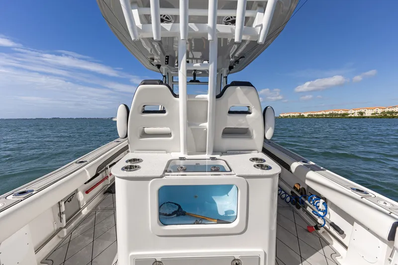 Slide: The Image of 2024 Tidewater 3100 Carolina Bay boat interior with seating and fishing equipment on open water. - 33