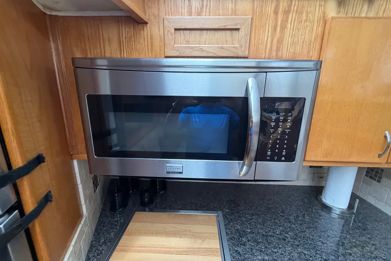 Slide: The Image of Stainless steel microwave in 1989 Chris-Craft 427 Catalina kitchen, surrounded by wooden cabinetry. - 38