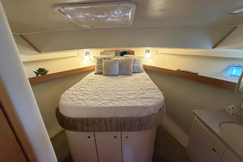 Slide: The Image of Cozy cabin interior of 1989 Chris-Craft 427 Catalina with plush bedding and ambient lighting. - 44