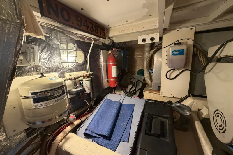 Slide: The Image of Engine room of 1989 Chris-Craft 427 Catalina with equipment and safety gear. - 52