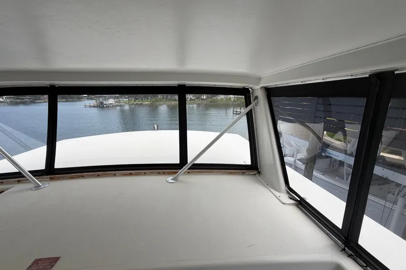 Slide: The Image of Interior view from 1989 Chris-Craft 427 Catalina yacht, overlooking serene waterfront. - 23