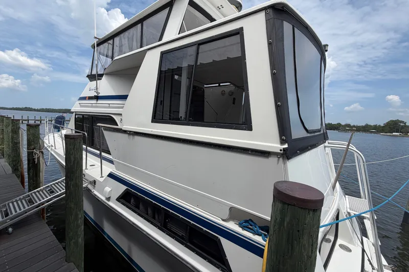 Slide: The Image of 1989 Chris-Craft 427 Catalina yacht docked by the water on a sunny day. - 7