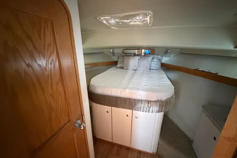 Slide: The Image of Cozy cabin interior of 1989 Chris-Craft 427 Catalina with a comfortable bed and wooden accents. - 42