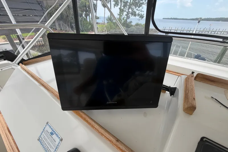 Slide: The Image of Garmin display on 1989 Chris-Craft 427 Catalina yacht, overlooking scenic waterfront. - 18