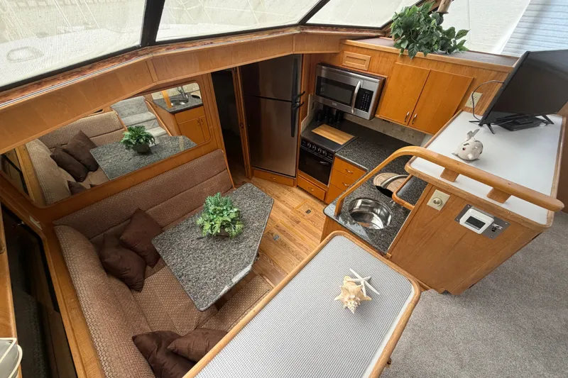 Slide: The Image of Interior of 1989 Chris-Craft 427 Catalina yacht with modern kitchen and cozy seating area. - 30