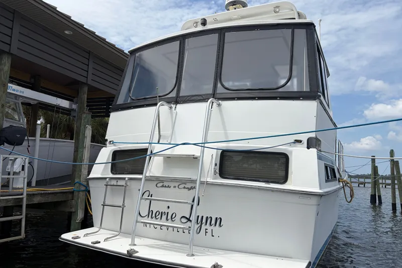 Slide: The Image of 1989 Chris-Craft 427 Catalina docked, rear view with "Cherie Lynn" name visible. - 6