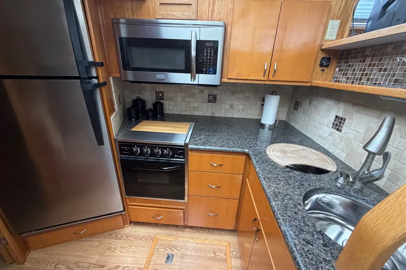 Slide: The Image of 1989 Chris-Craft 427 Catalina kitchen with stainless appliances and granite countertops. - 34