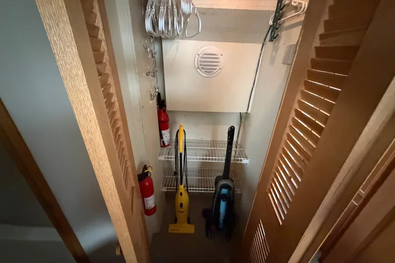 Slide: The Image of Storage closet on 1989 Chris-Craft 427 Catalina with cleaning supplies and fire extinguishers. - 63
