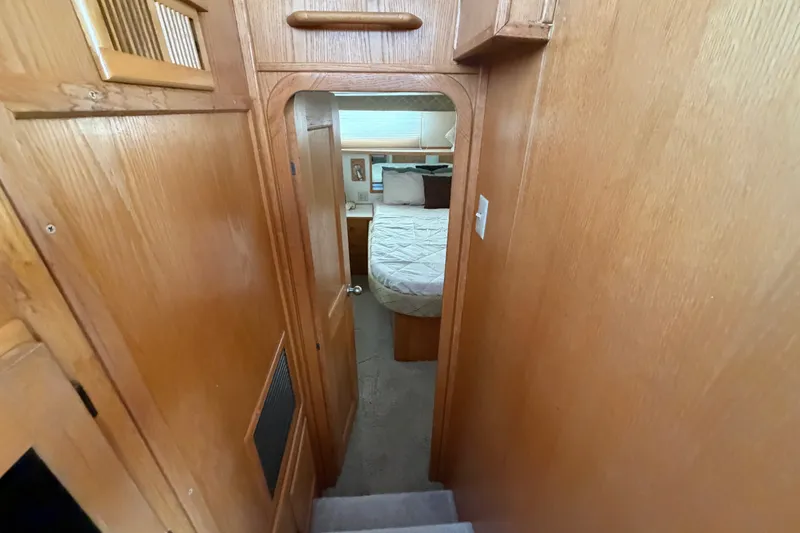 Slide: The Image of Interior view of 1989 Chris-Craft 427 Catalina, featuring a cozy bedroom with wooden paneling. - 55