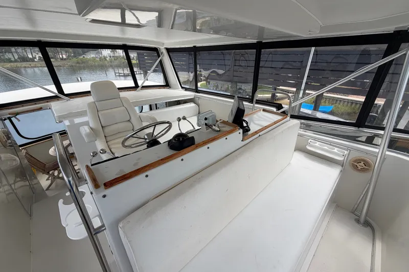 Slide: The Image of 1989 Chris-Craft 427 Catalina helm with white seating and panoramic windows. - 24