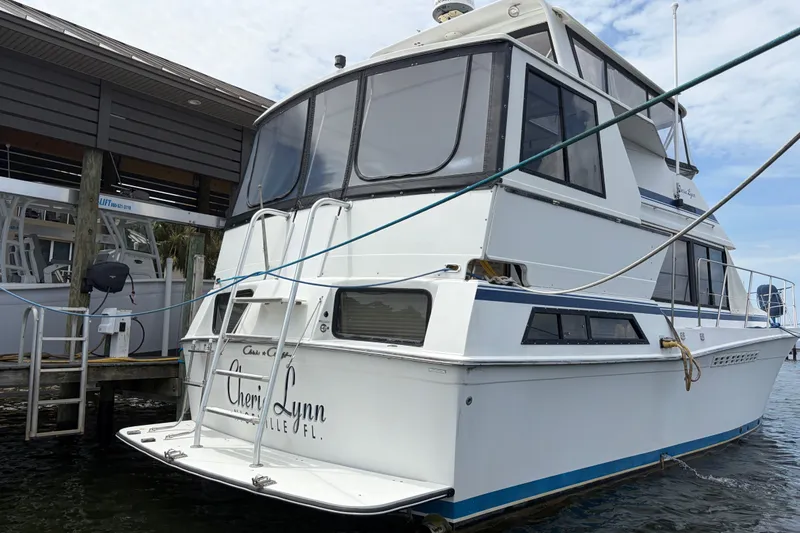 Slide: The Image of 1989 Chris-Craft 427 Catalina yacht docked, featuring spacious cabin and sleek design. - 4
