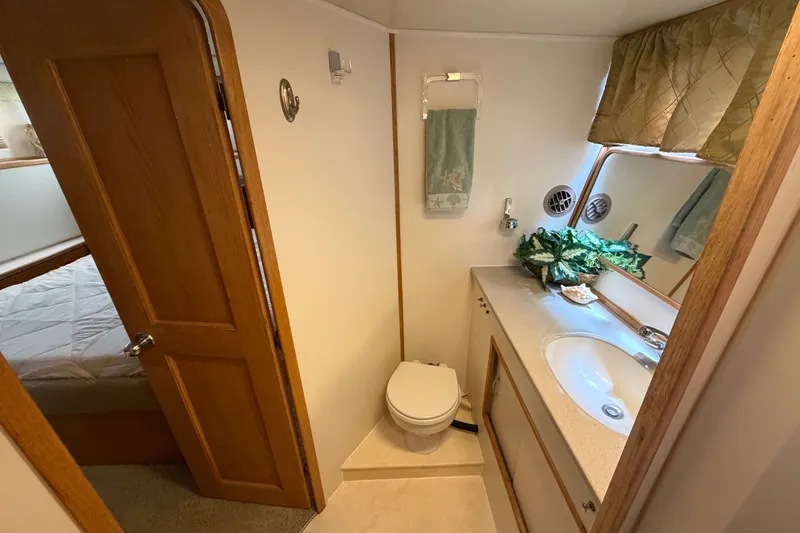 Slide: The Image of Bathroom interior of 1989 Chris-Craft 427 Catalina yacht, featuring sink and toilet. - 62