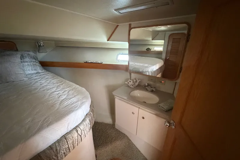 Slide: The Image of Cozy cabin interior of 1989 Chris-Craft 427 Catalina with bed and vanity area. - 43