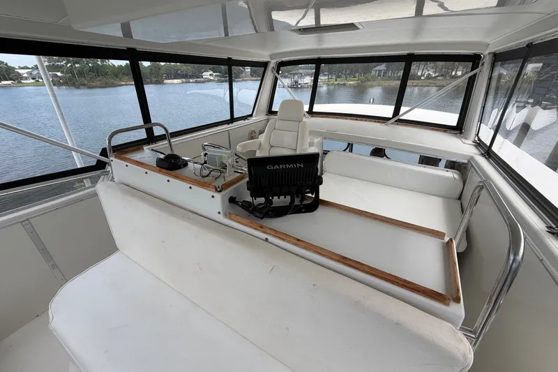 Slide: The Image of 1989 Chris-Craft 427 Catalina boat interior with helm, seating, and Garmin navigation system. - 25
