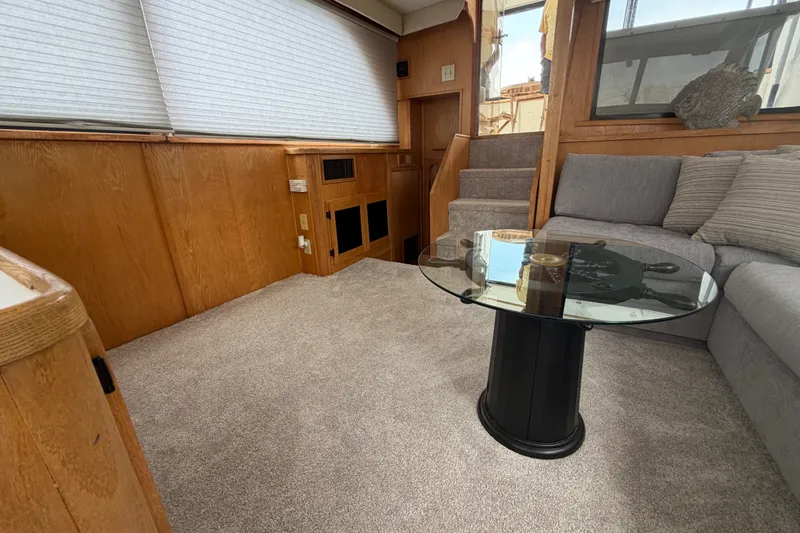 Slide: The Image of Interior of 1989 Chris-Craft 427 Catalina with cozy seating and glass-top table. - 31