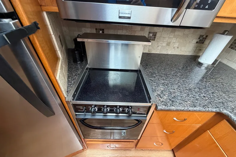Slide: The Image of Kitchen area of 1989 Chris-Craft 427 Catalina with stove and granite countertop. - 40