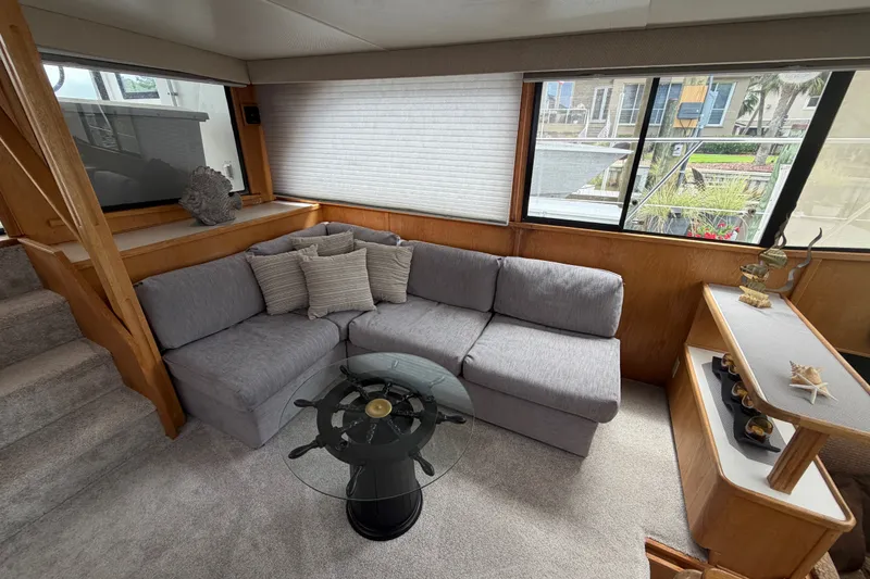 Slide: The Image of Interior of 1989 Chris-Craft 427 Catalina with gray sofa and nautical decor. - 29
