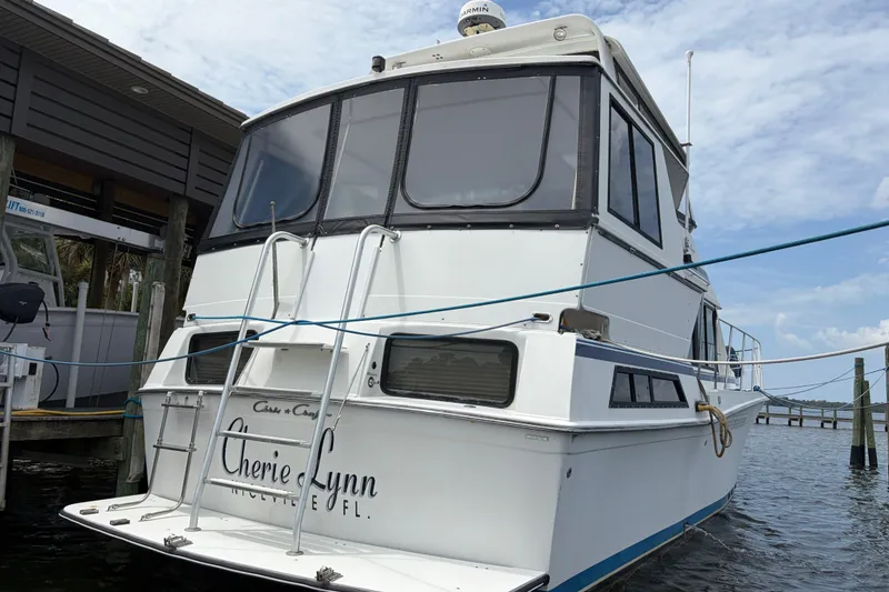 Slide: The Image of 1989 Chris-Craft 427 Catalina docked, rear view with "Cherie Lynn" name visible. - 5