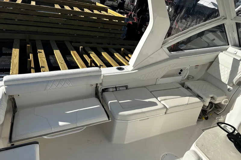 Slide: The Image of Interior of 2023 Edgewater 262CX Crossover boat with white seating and modern design. - 12