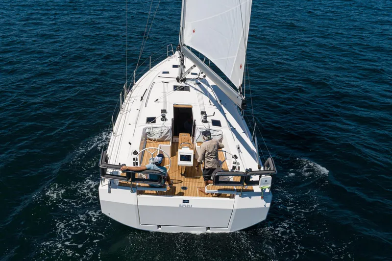 Slide: The Image of 2023 Bavaria C42 sailboat cruising on open water, viewed from above. - 19