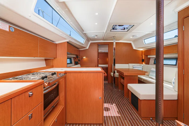Slide: The Image of Modern 2023 Bavaria C42 yacht interior with wood finish, kitchen, and seating area. - 39