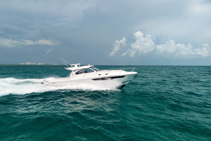 Slide: The Image of 2025 Pursuit OS 405 Offshore cruising on open sea under cloudy sky. - 12