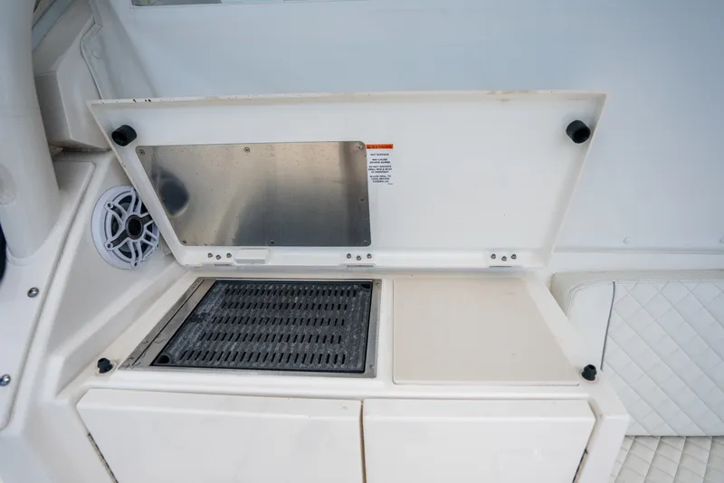 Slide: The Image of Outdoor grill and seating area on 2025 Pursuit OS 405 Offshore boat. - 32
