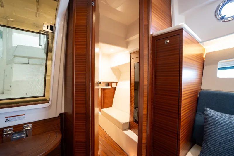 Slide: The Image of Luxurious interior of 2025 Pursuit OS 405 Offshore boat, featuring elegant wood finishes and cozy seating. - 67