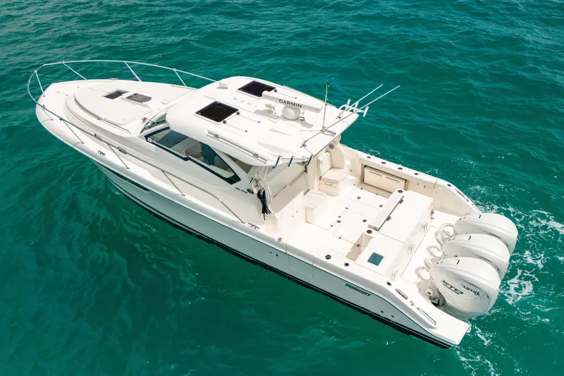Slide: The Image of 2025 Pursuit OS 405 Offshore boat cruising on clear blue water. - 8