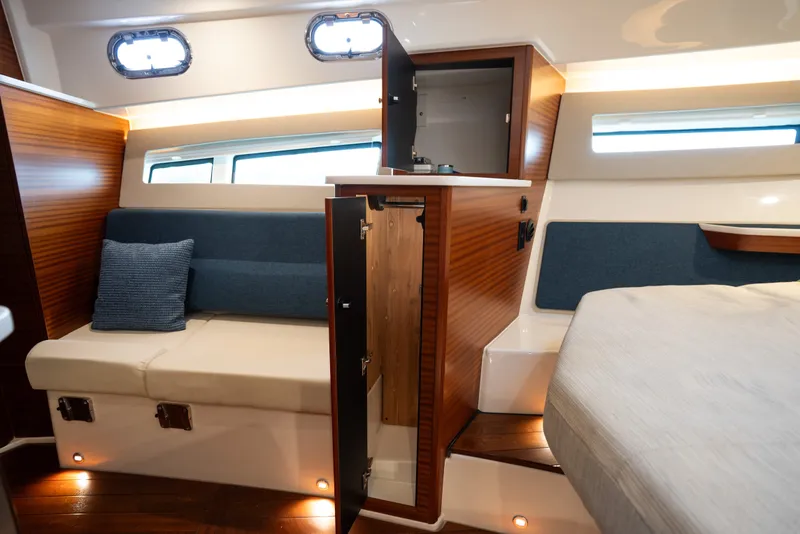 Slide: The Image of 2025 Pursuit OS 405 Offshore cabin interior with seating, storage, and modern design. - 60