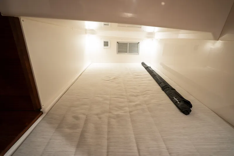 Slide: The Image of Interior cabin of 2025 Pursuit OS 405 Offshore boat, featuring a spacious sleeping area. - 70