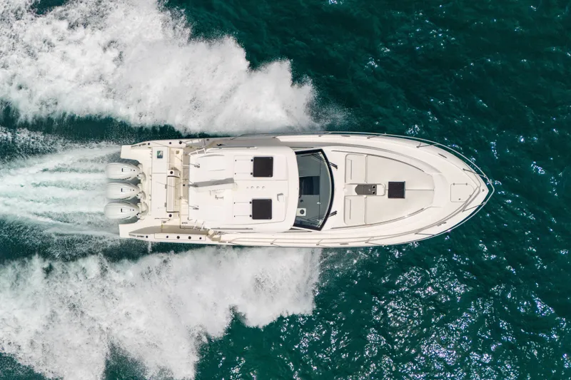 Slide: The Image of Aerial view of 2025 Pursuit OS 405 Offshore boat cruising on open water. - 11