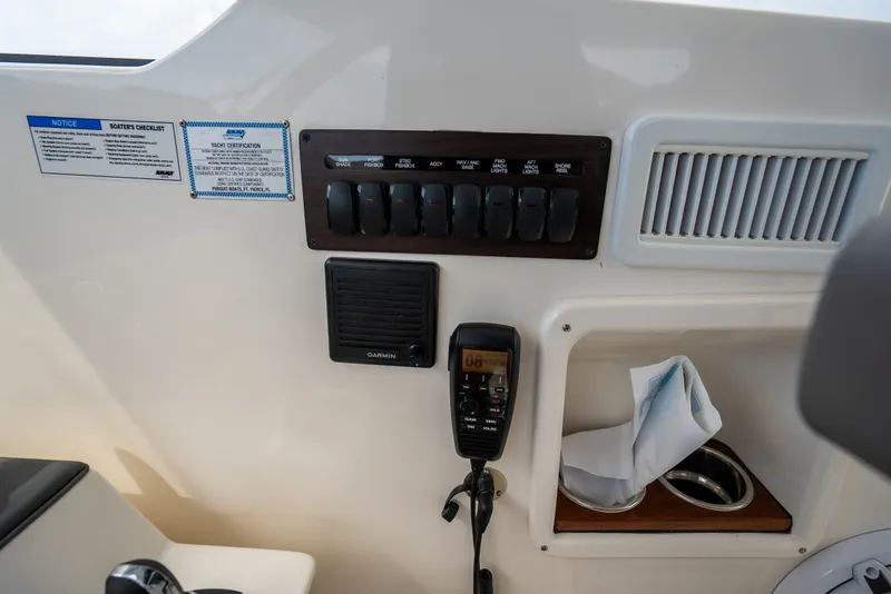 Slide: The Image of Control panel of 2025 Pursuit OS 405 Offshore boat with switches and Garmin device. - 45