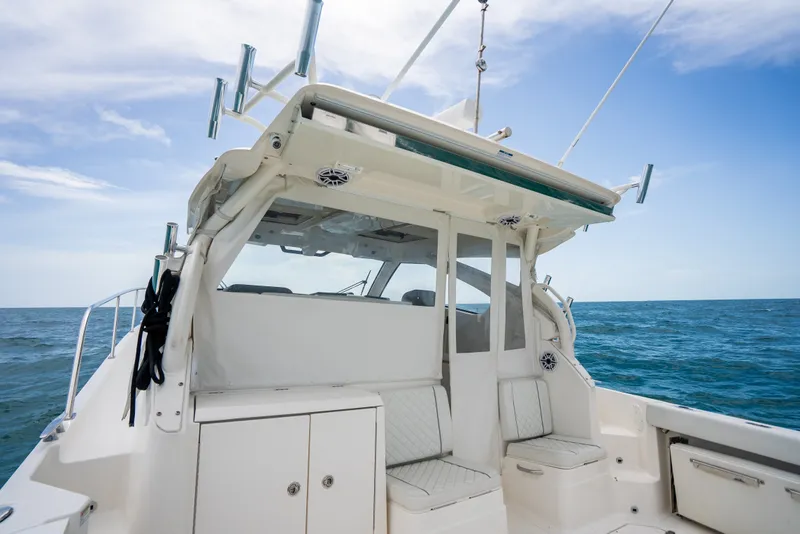 Slide: The Image of 2025 Pursuit OS 405 Offshore boat interior with ocean backdrop. - 23