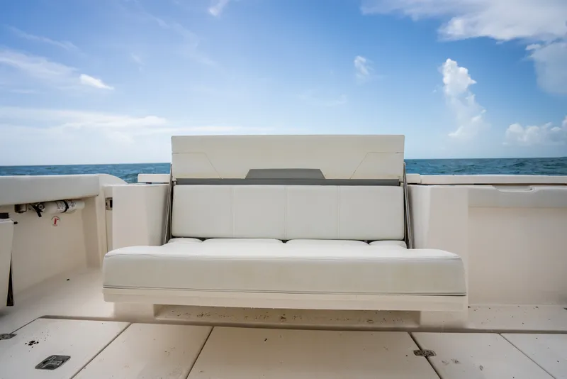 Slide: The Image of 2025 Pursuit OS 405 Offshore boat with white seating, ocean backdrop, and clear blue sky. - 33