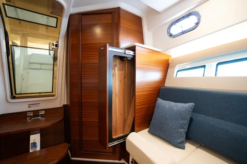 Slide: The Image of Luxurious interior of 2025 Pursuit OS 405 Offshore boat with wooden cabinetry and seating. - 59