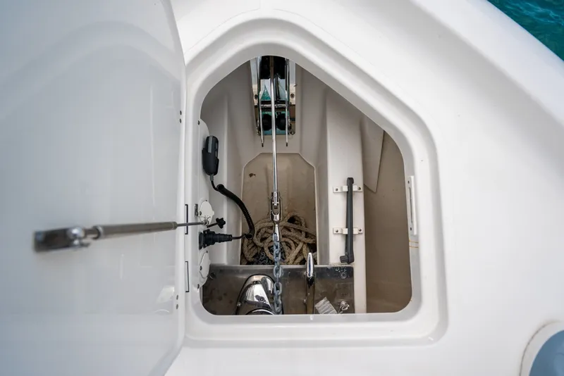 Slide: The Image of Anchor compartment of 2025 Pursuit OS 405 Offshore boat, featuring rope and equipment. - 19