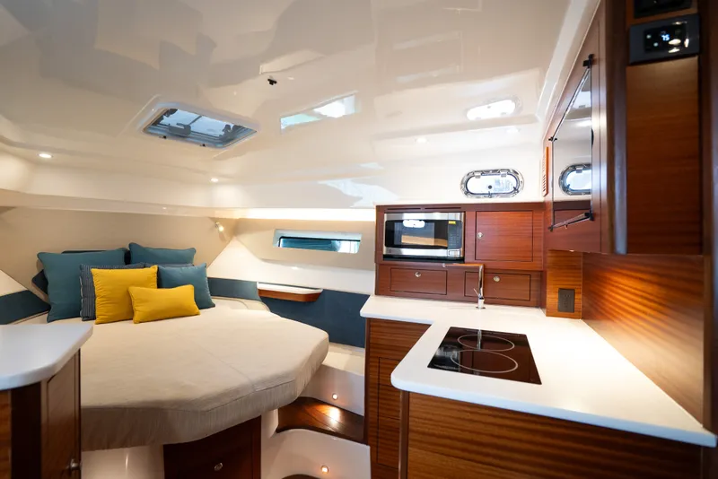 Slide: The Image of Luxurious interior of 2025 Pursuit OS 405 Offshore yacht with modern kitchen and cozy sleeping area. - 52