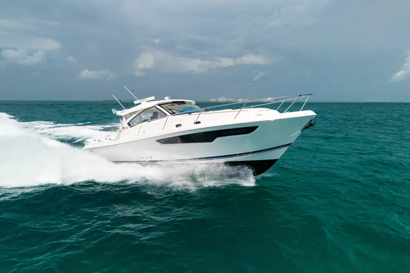 Slide: The Image of 2025 Pursuit OS 405 Offshore cruising on open ocean waters. - 13
