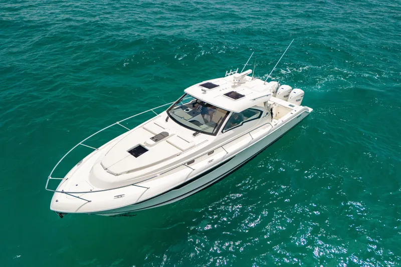 Slide: The Image of 2025 Pursuit OS 405 Offshore boat cruising on clear turquoise waters. - 9