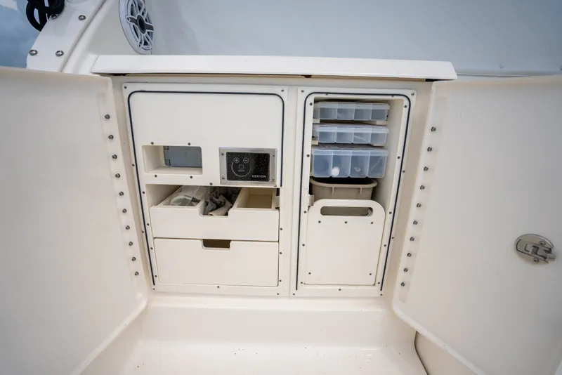 Slide: The Image of 2025 Pursuit OS 405 Offshore boat storage compartments with organized drawers and containers. - 31