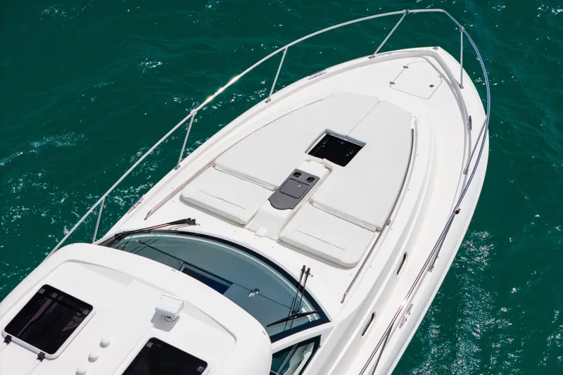 Slide: The Image of 2025 Pursuit OS 405 Offshore boat on clear blue water. - 2